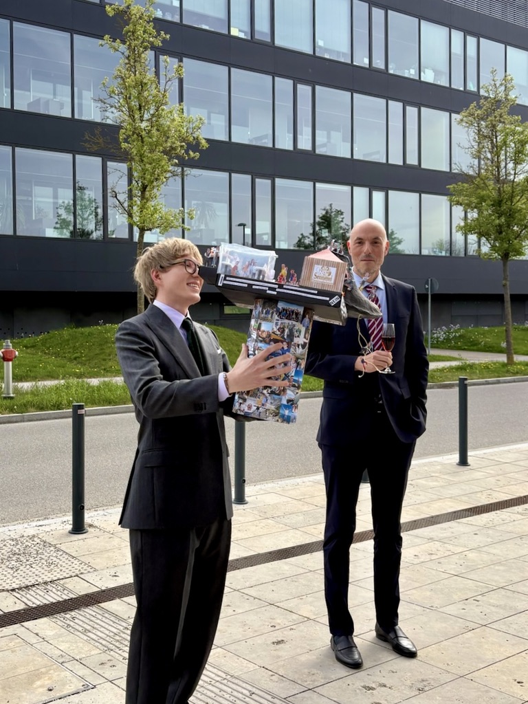 Maximilian Schuh and Stephan Sieber holding a handmade photo collage after the doctoral defense